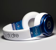 two white headphones with blue logo on them