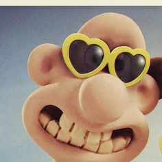 a close up of a cartoon character with heart shaped glasses on his face and mouth