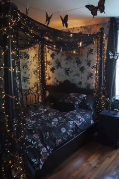 a bed that is in a room with lights on the ceiling and butterflies flying above it