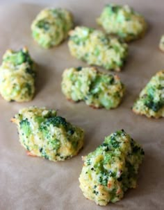 broccoli florets are arranged on a sheet of wax paper and ready to be baked