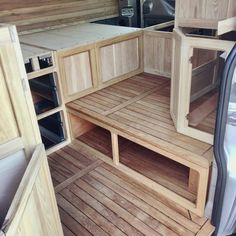 the inside of a van with wood flooring and built - in storage compartments on each side