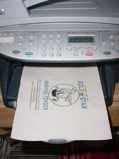 a printer sitting on top of a table next to a piece of paper