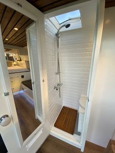 a walk in shower sitting inside of a bathroom