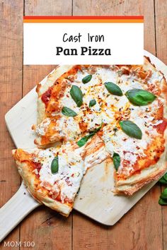 a pizza sitting on top of a wooden cutting board next to a sign that says cast iron pan pizza