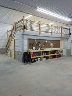 the inside of a garage with stairs and workbench