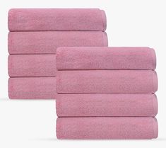 four pink towels stacked on top of each other in front of a white background,