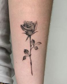 a black and white rose tattoo on the leg