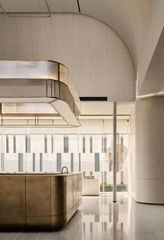 the interior of a modern office building with an elegant countertop and stainless steel appliances