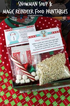 a box filled with candy and marshmallows on top of a red table cloth