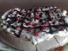 a desert with white chocolate and cherries on it