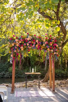 an outdoor wedding setup with flowers and candles