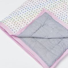 three baby blankets folded on top of each other with hearts and dots printed on them