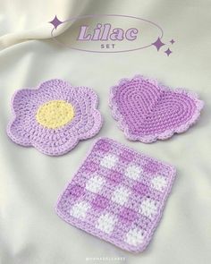 three crocheted flower coasters are shown on a white sheet with the lilac set logo above them