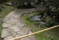 a stone path in the middle of a garden