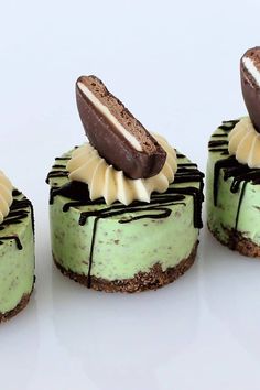 three small desserts with chocolate and green frosting