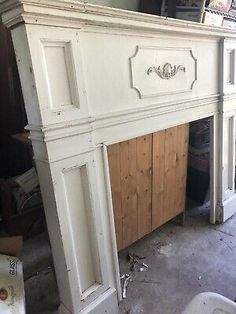 an old fireplace is being painted white with wood paneling on the top and bottom