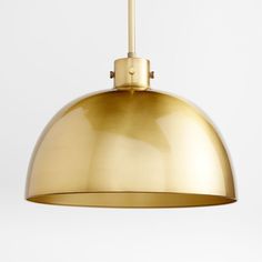 a large brass pendant light hanging from the ceiling