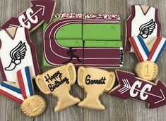 decorated cookies are arranged in the shape of baseball bats, mitts, and gloves