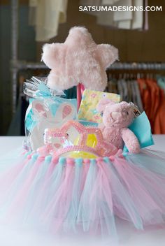 a pink teddy bear sitting on top of a tutu