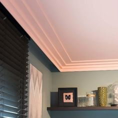 a bathroom with two shelves above the toilet