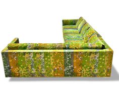 an upholstered couch with green and yellow fabric