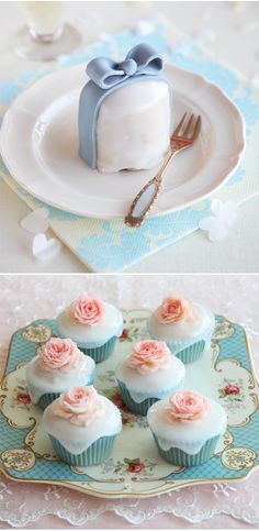 cupcakes with white frosting and pink roses on them are sitting on a plate