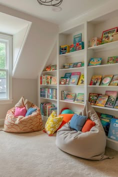 two bean bag chairs sitting in front of bookshelves filled with children's books