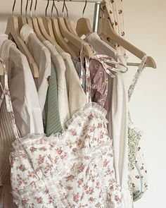 there are many different types of clothes hanging on the rack