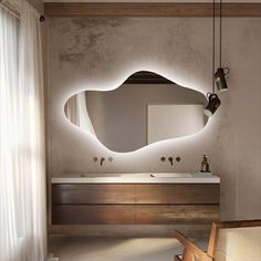 a bathroom with a large mirror and lights on the wall