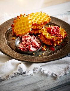 waffles on a plate with strawberry jam and butter