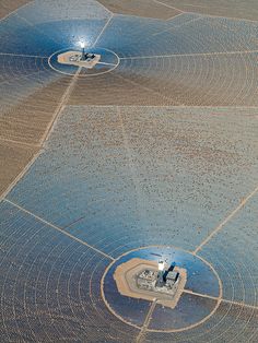 an aerial view of two large solar panels