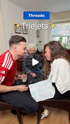 a man sitting on top of a chair next to a woman in a red shirt