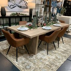 a dining room table with chairs and plates on it