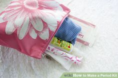 a pink and white flowered bag with some items in it