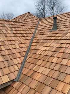 the roof of a house with two different types of wood shingles on top of it