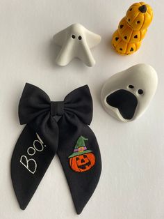 three halloween decorations are shown on a white surface