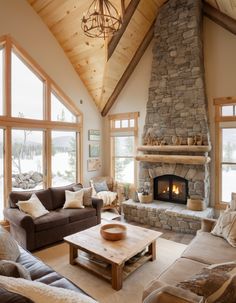 a living room filled with furniture and a fire place in the middle of a room