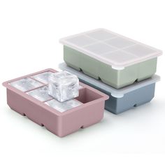 two plastic containers with ice cubes in them on a white background, one is pink and the other is blue