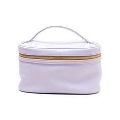 a white bag with gold zippers on the inside and outside, sitting on a white surface