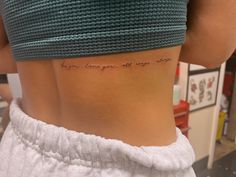 the back of a woman's stomach with writing on it