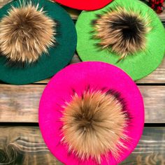 four different colored hats with fur on them