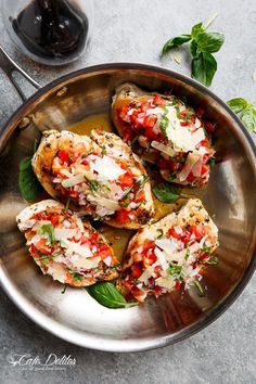 two pita breads with chicken, tomatoes and lettuce on a cutting board