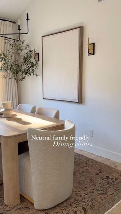 a dining room table and chairs with a plant in the corner on the wall behind it