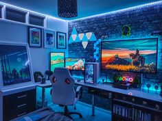 a gaming room with two monitors and several games on the wall, all lit up