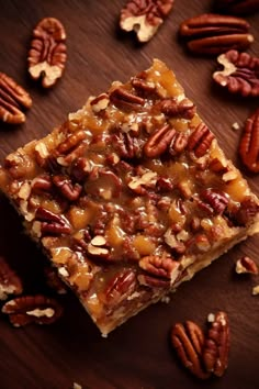 pecan bars with caramel toppings on a wooden table