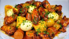 a white plate topped with chicken, potatoes and carrots