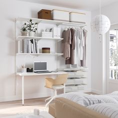 a bedroom with a bed, desk and white shelving unit in the corner next to a window