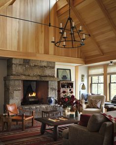 a living room filled with furniture and a fire place in the middle of an open floor plan