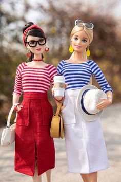 two dolls are standing next to each other