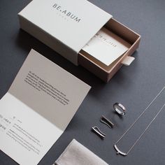 the contents of a jewelry set are laid out on a gray surface, including necklaces and earrings